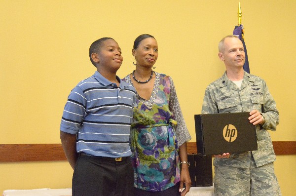 In June, Antonio Douglas Jr. (l), recipient of the chapter's Science Fair Award, receives an HP Netbook from Lt. Col. Brian Bakshas, USAF, and Glenda Robinson, chapter vice president for education and scholarships.